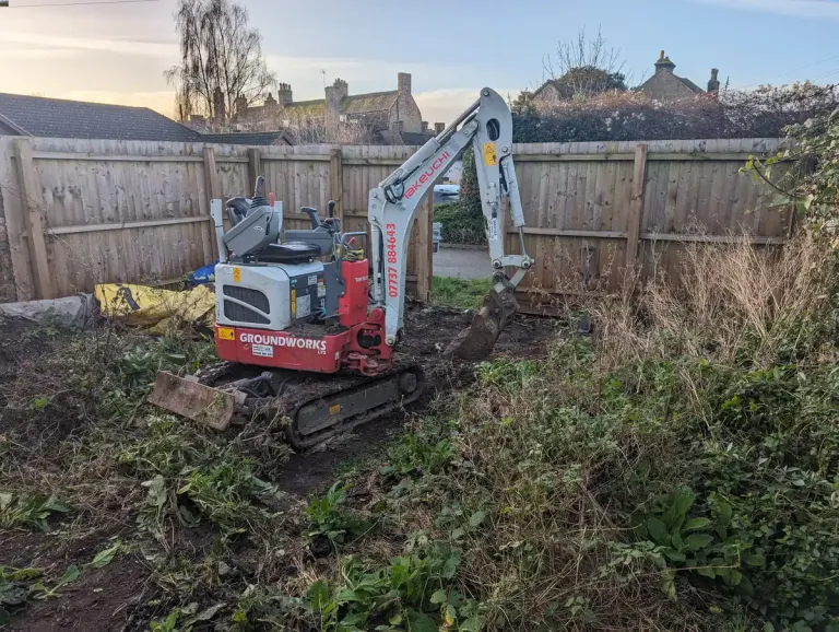 digger in unkept garden