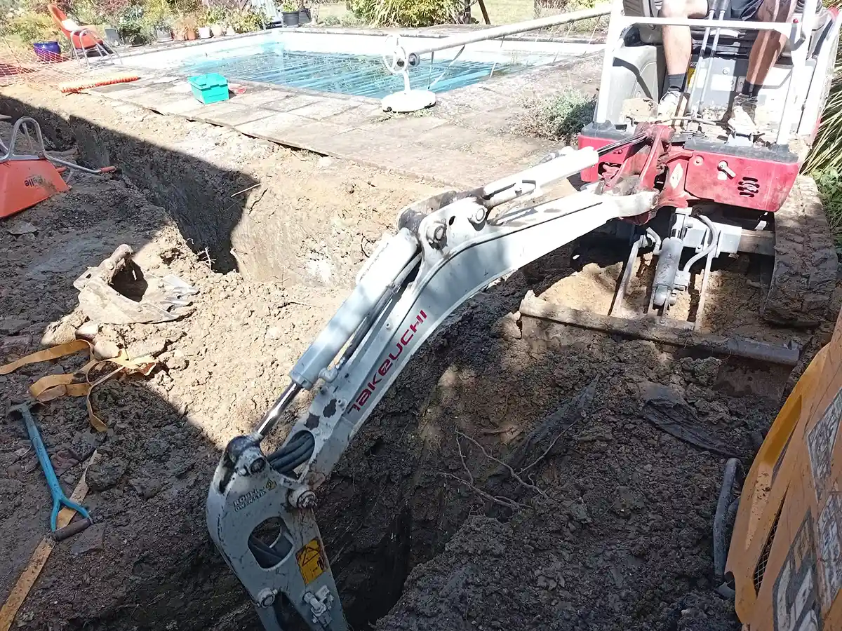 digger digging corner of foundation trench