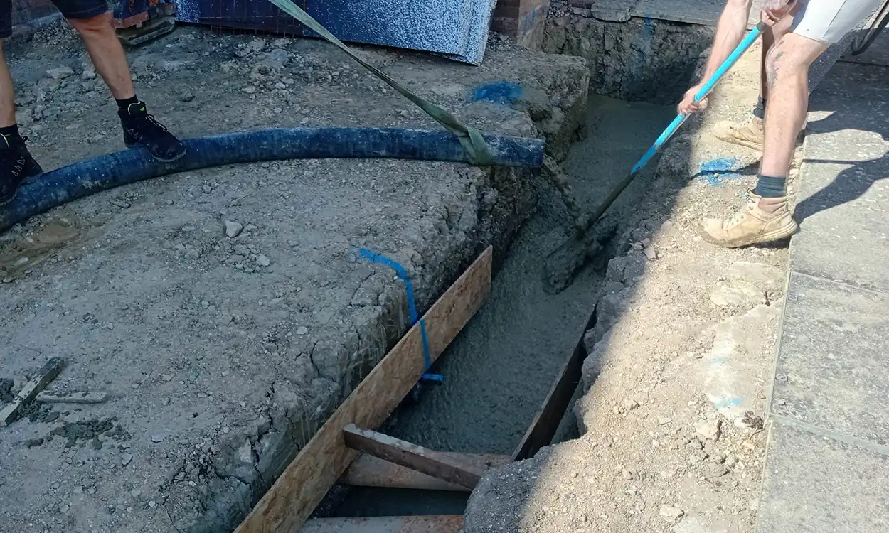 concrete being pumped into footing