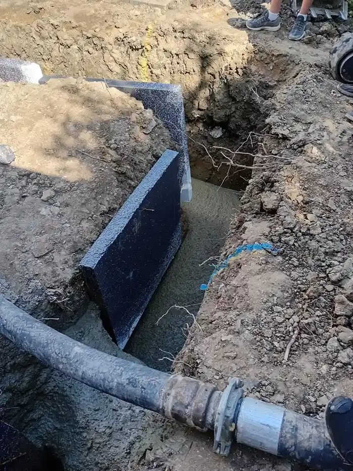 concrete being pumped into trench